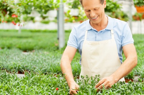Worker using protective equipment during garden maintenance tasks