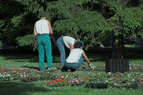 Worker wearing PPE while using landscaping equipment on site